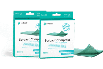Sorbact Compress -pakkauksia ja sidos vieressä.